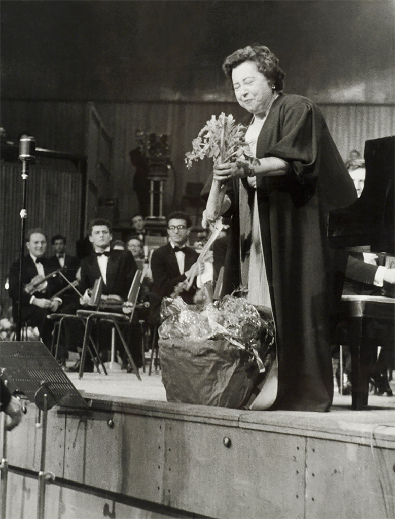 Yvonne Arnaud receiving a bouquet of vegetables